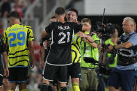 FC Cincinnati defender Matt Miazga (21) hugs Arsenal midfielder Declan Rice after the MLS All-Star soccer match, Wednesday, July 19, 2023, in Washington. Arsenal won 5-0. (AP Photo/Alex Brandon)