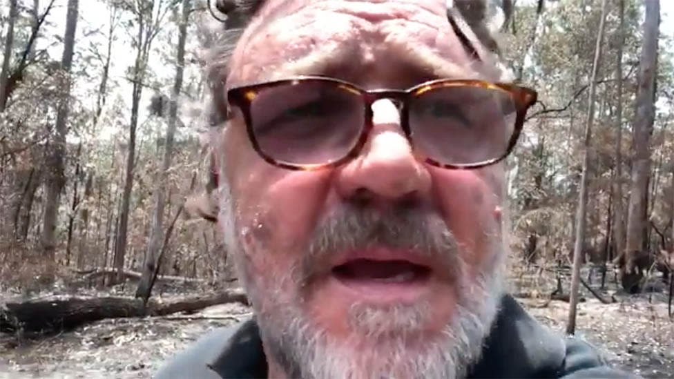 Russell Crowe appears in a self-shot video of his fire damaged property in NSW