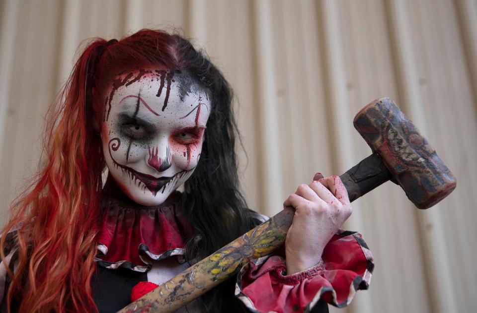 Gianna Stanton of Westhampton, NJ, is armed and ready as she plays a possessed clown at Six Flags Great Adventure's Fright Fest in 2018.