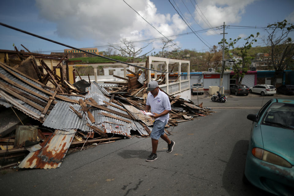 <p>Luis Menendez, a mail man for the U.S. Postal Service, delivers mail at an area affected by Hurricane Maria in the island of Vieques, Puerto Rico, Oct. 7, 2017. (Photo: Carlos Barria/Reuters) </p>