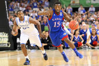 Elijah Johnson #15 of the Kansas Jayhawks drives on Marquis Teague #25 of the Kentucky Wildcats in the first half in the National Championship Game of the 2012 NCAA Division I Men's Basketball Tournament at the Mercedes-Benz Superdome on April 2, 2012 in New Orleans, Louisiana. (Photo by Jeff Gross/Getty Images)