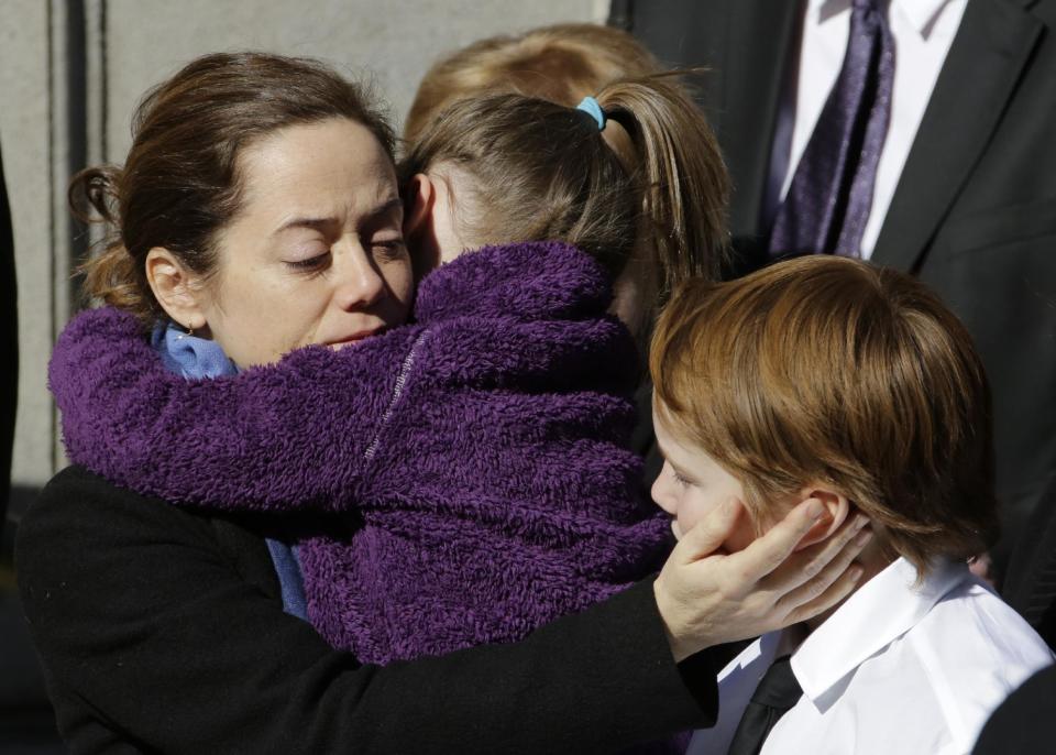 Mimi O'Donnell, estranged partner of actor Philip Seymour Hoffman, comforts two of their children, daughter Willa, and son Cooper as his casket arrives at the Church of St. Ignatius Loyola, Friday, Feb. 7, 2014 in New York. Hoffman, 46, was found dead Sunday of an apparent heroin overdose. (AP Photo/Mark Lennihan)