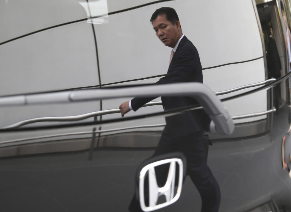 A man is reflected on a Honda model on display at Honda Motor Co. headquarters in Tokyo, Friday, April 25, 2014. Honda's profit for the fiscal fourth quarter zoomed to more than double the previous year's as the benefits of a weak yen added to strong sales. (AP Photo/Koji Sasahara)