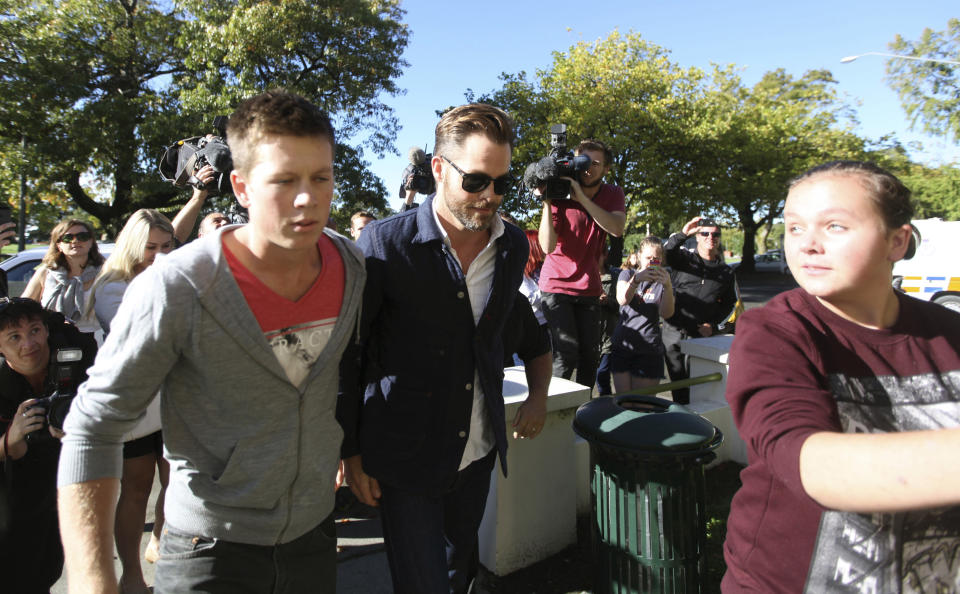 Hollywood actor Chris Pine, center, arrives at a courthouse in Ashburton, New Zealand, Monday, March 17, 2014. Pine, known for playing Captain Kirk in the "Star Trek" movies, pleaded guilty in the New Zealand court to drunken-driving charges. The 33-year-old was fined $93 New Zealand dollars ($79) and had his New Zealand driver’s license suspended for six months during a hearing at the Ashburton District Court. (AP Photo/Ashburton Guardian, Tetsuro Mitomo) NEW ZEALAND OUT, AUSTRALIA OUT, NO SALES