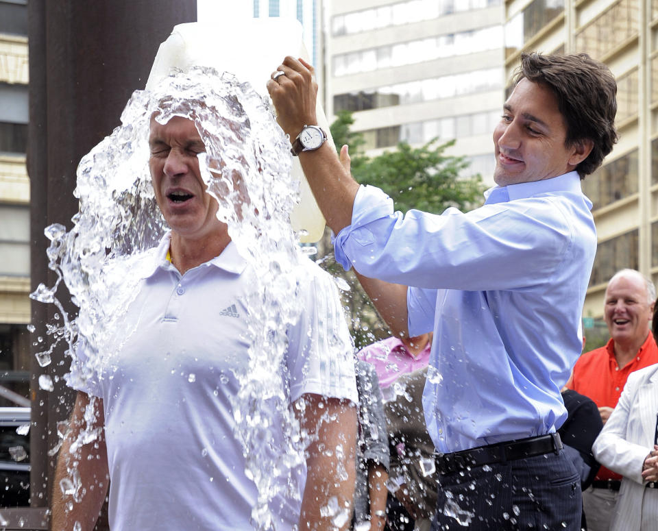 Justin Trudeau dumps a bucket of ice water onto Sean Casey for the ALS ice bucket challenge. (Photo: Dan Riedlhuber / Reuters)
