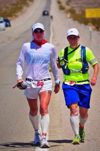 Running through Death Valley wearing bib No. 50, runner Cheryl Zwarkowski and support team member Lo Stender approach mile 72 of the Badwater 135 Ultramarathon in July 2018.