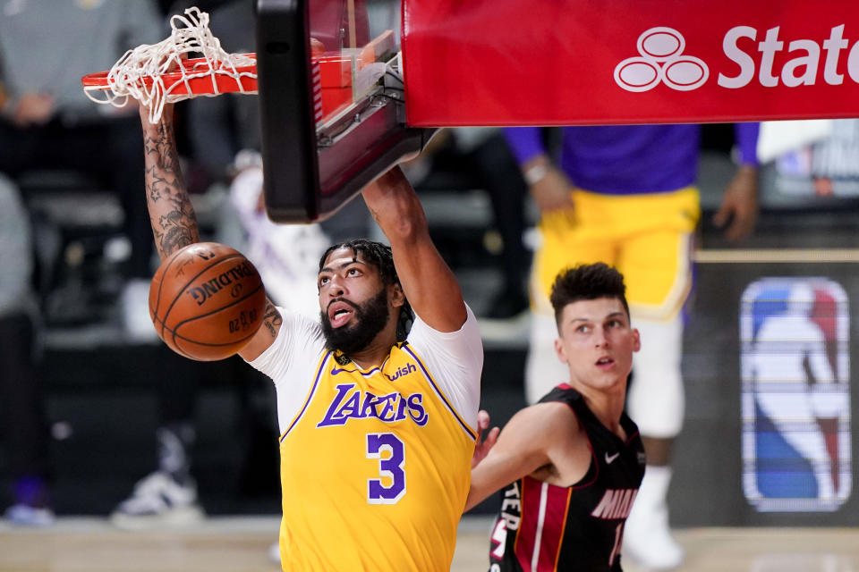 Los Angeles Lakers forward Anthony Davis dunks as Miami Heat guard Tyler Herro looks on during the first half in Game 4 of basketball's NBA Finals Tuesday, Oct. 6, 2020, in Lake Buena Vista, Fla. (AP Photo/Mark J. Terrill)