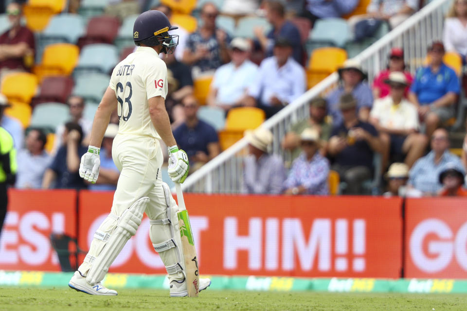 England's Jos Buttler walks from the field after he was dismissed during day one of the first Ashes cricket test at the Gabba in Brisbane, Australia, Wednesday, Dec. 8, 2021. (AP Photo/Tertius Pickard)