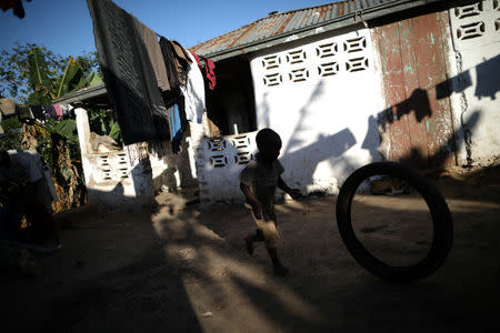 Romenson Exalus plays with a tire at his house in Boucan Ferdinand, Haiti, April 10, 2018. REUTERS/Andres Martinez Casares