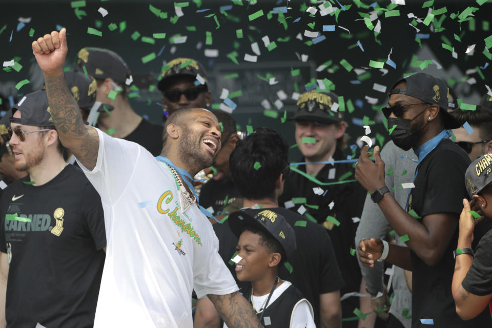 Milwaukee Bucks' P.J. Tucker dances as confetti falls during a parade celebrating the Milwaukee Bucks' NBA Championship basketball team Thursday, July 22, 2021, in Milwaukee. (AP Photo/Aaron Gash)