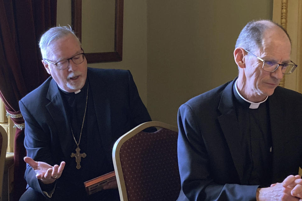 Bishop Christopher Coyne, left, of the Roman Catholic Diocese of Vermont, testifies before the Vermont Senate Judiciary Committee at the State House, Friday, March 3, 2023, in Montpelier, Vt. Coyne said the diocese is opposed to a bill that would remove an exemption to the state's child abuse and neglect reporting laws for members of the clergy. At right is Rev. Msgr. John McDermott. (AP Photo/Lisa Rathke)