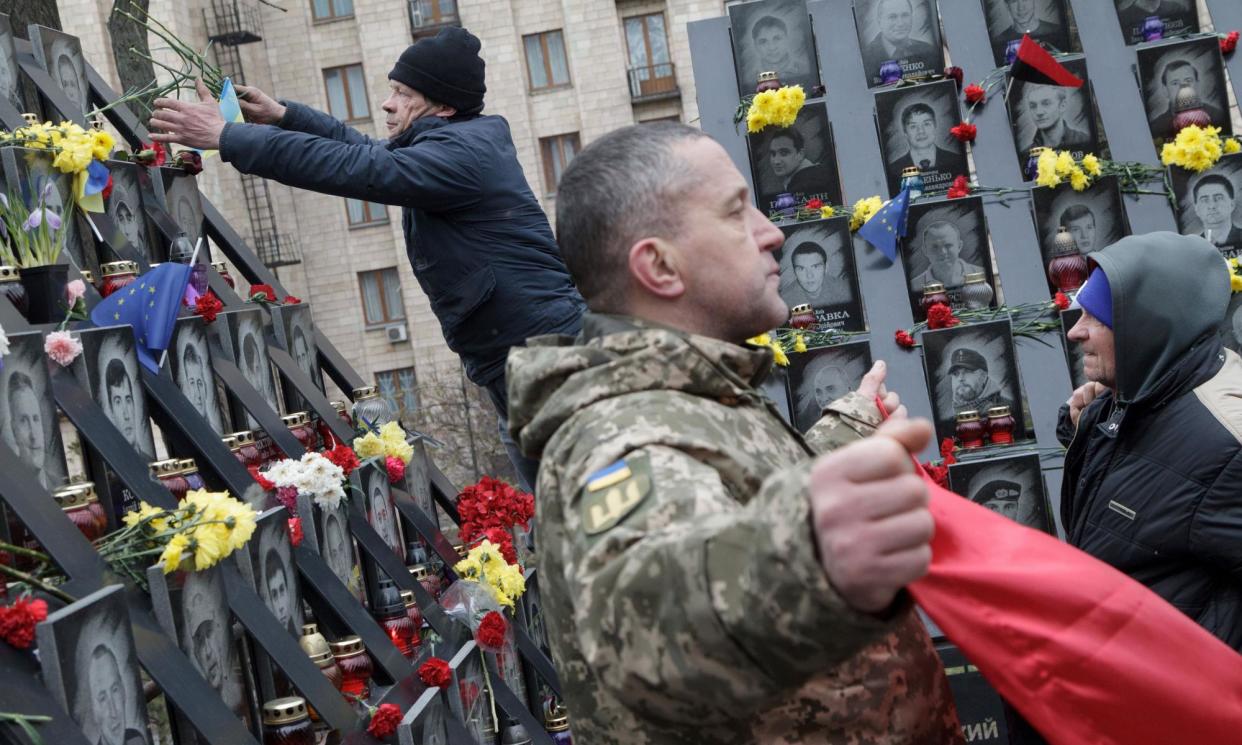 <span>People pay tribute at a memorial to participants of the Revolution of Dignity who were killed in Kyiv, Ukraine, 10 years ago.</span><span>Photograph: Ukrinform/REX/Shutterstock</span>