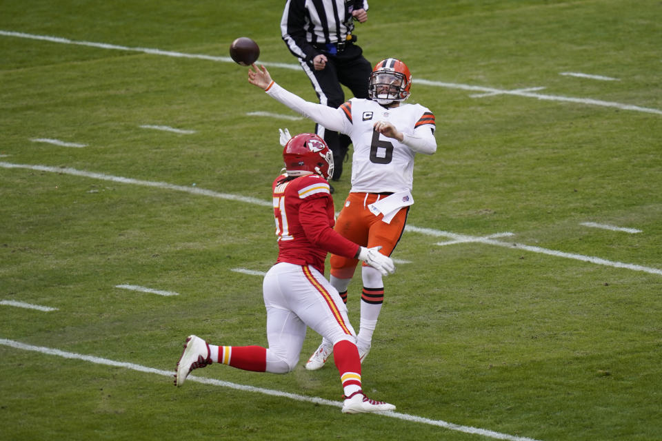 Cleveland Browns quarterback Baker Mayfield (6) throws a pass over Kansas City Chiefs defensive end Mike Danna during the first half of an NFL divisional round football game, Sunday, Jan. 17, 2021, in Kansas City. (AP Photo/Orlin Wagner)