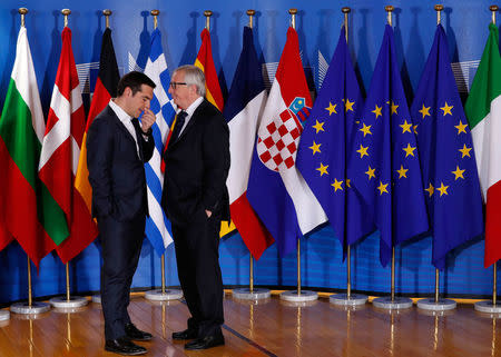 Greek Prime Minister Alexis Tsipras is welcomed by European Commission President Jean-Claude Juncker at the start of an emergency European Union leaders summit on immigration at the EU Commission headquarters in Brussels, Belgium June 24, 2018. REUTERS/Yves Herman/Pool