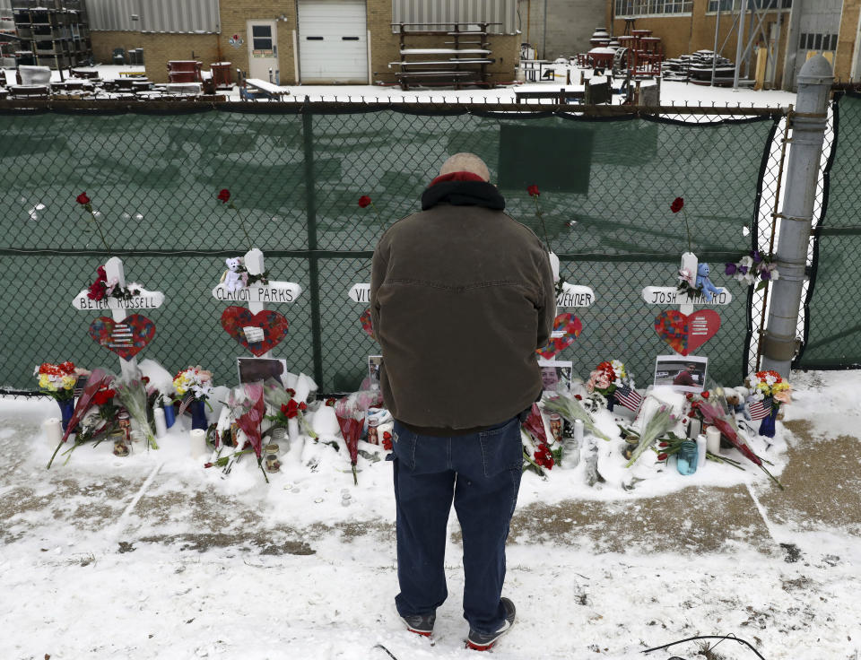 A man pays his respects at a makeshift memorial in Aurora, Illinois, near the Henry Pratt manufacturing company, where a gunman killed five people on Feb. 15. It was the 39th mass shooting in the U.S. this year. (Photo: ASSOCIATED PRESS)