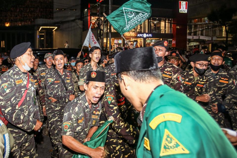 Members of an Islamic organisation protest in front of the Holywings bar in Jakarta on 24 June (AFP via Getty)