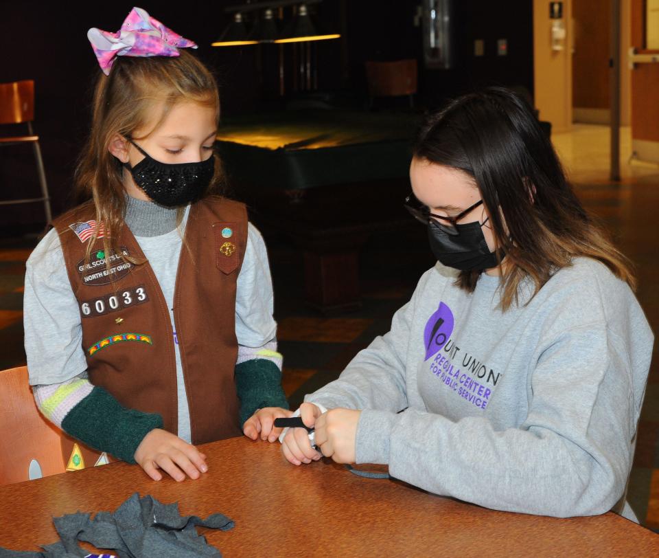 University of Mount Union student Kaylee Adkins assists Holly Rosenbluth, 8, in creating pet toys that will be donated to the Humane Society. The pair was working on the project Saturday, Jan. 22, 2022.