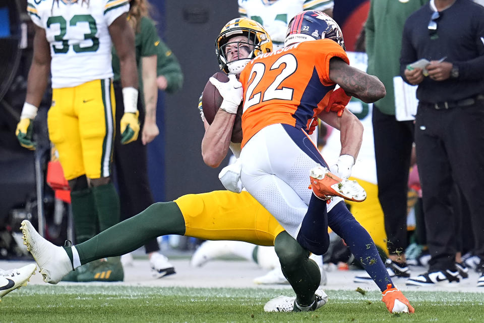 Green Bay Packers tight end Luke Musgrave, rear, is hit by Denver Broncos safety Kareem Jackson (22) during the second half of an NFL football game in Denver, Sunday, Oct. 22, 2023. Jackson was penalized for the hit and disqualified from the game after the play. (AP Photo/Jack Dempsey)