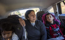 Maria Campos, 52, fights back tears while approaching the Stewart Detention Center with her grandkids to visit her son, Sunday, Nov. 10, 2019, in Lumpkin, Ga. Campos' son was deported a year ago from the same ICE facility where another son is now detained. "My first son, my heart is broken because he's not here. I don't want the same for the second one," said Campos. "This place is a horrible place because not all the lawyers want to go there and fight for our family members." Immigrants being held in the rural detention center face a host of challenges in fighting their cases. The town has few available resources, only three immigration lawyers work there full time. In the vacuum, a small network has sprung up to help the immigrants. (AP Photo/David Goldman)