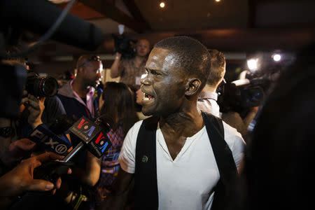 Ernest St. Pierre yells as he finds out that he will not be given $300 by Chinese millionaire Chen Guangbiao during a lunch sponsored for hundreds of needy New Yorkers at Loeb Boathouse in New York's Central Park June 25, 2014. REUTERS/Lucas Jackson