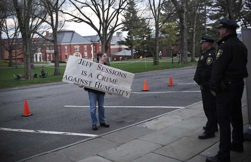 A protester speaks to police outside Johnson Chapel, where former attorney general Jeff Sessions is speaking, at Amherst College in Amherst, Mass., Wednesday, April 24, 2019. (AP Photo/Jessica Hill)