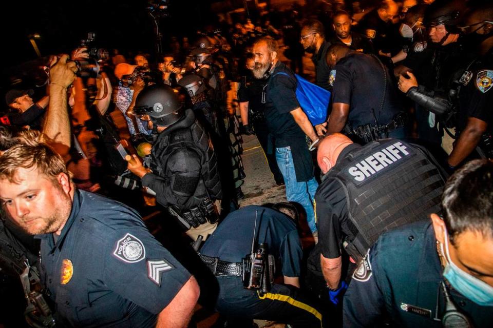 A demonstrator protesting the police killing of Andrew Brown Jr.are arrested Tuesday, April 27, 2021 in downtown Elizabeth City. At least six protesters were arrested when police in riot gear marched toward roughly a dozen protesters two hours past curfew. Protesters were peaceful but refused to clear the streets.