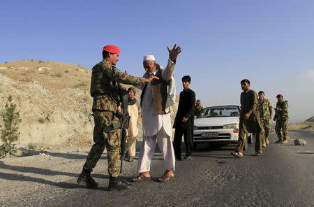 Afghan National Army soldiers (ANA) inspect passengers at a checkpoint on the outskirts of Jalalabad province, eastern Afghanistan, June 29, 2015. REUTERS/Parwiz