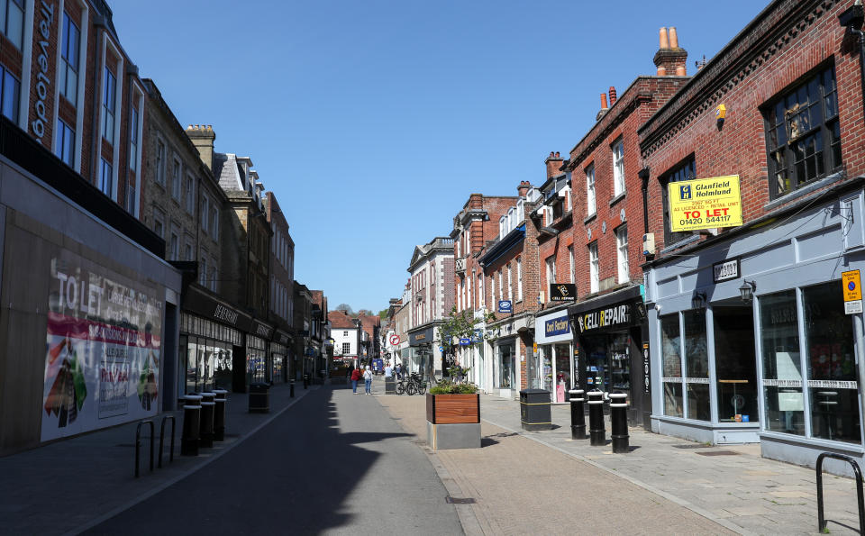 People walk along a near empty High Street in Winchester, as the UK continues in lockdown to help curb the spread of the coronavirus.