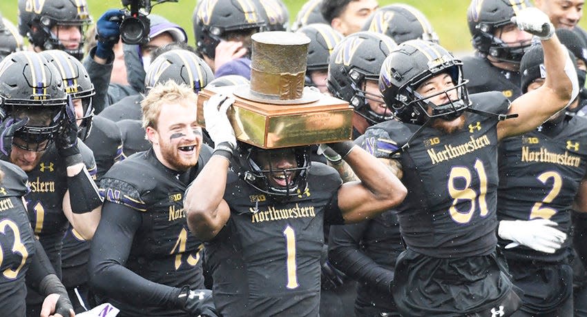 Dec 12, 2020; Evanston, Illinois, USA; Northwestern Wildcats running back Jesse Brown (1) raises the Land of Lincoln trophy after defeating the Illinois Fighting Illini at Ryan Field.