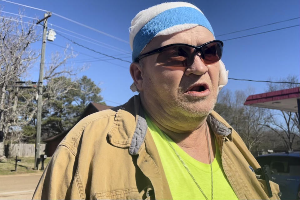 George Drane, who survived a mass shooting Friday that claimed the lives of 6 people, speaks during an interview on Saturday, Feb. 18, 2023, in front of a convenience store where the shootings began in Arkabutla, Miss. Drane’s girlfriend, Debra Crum, was the ex-wife of the shooting suspect, Richard Dale Crum. (AP Photo/Michael Goldberg)