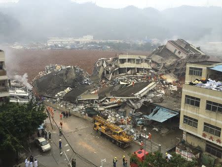 Damaged buildings are seen as rescuers search for survivors after a landslide hit an industrial park in Shenzhen, Guangdong province, China, December 20, 2015. REUTERS/China Daily