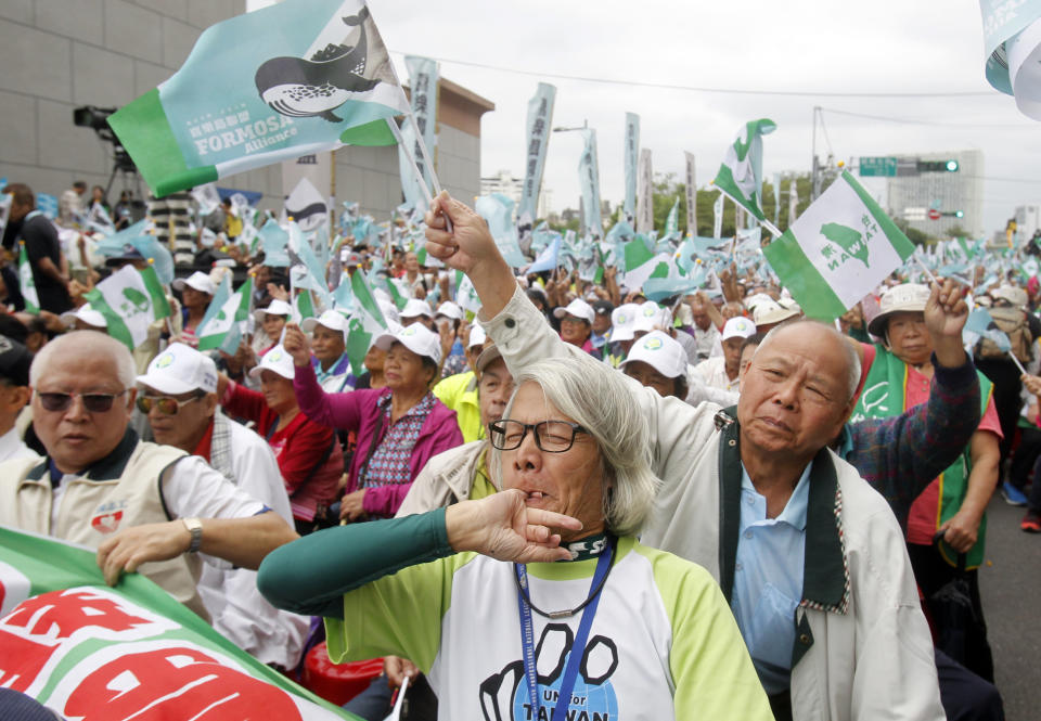 Pro-independence demonstrators shout slogans during a rally in Taipei, Taiwan, Saturday, Oct. 20, 2018. Thousands of the demonstrators gathered in Taiwan’s capital on Saturday to express their disapproval with China’s stance toward their island. (AP Photo/Chiang Ying-ying)