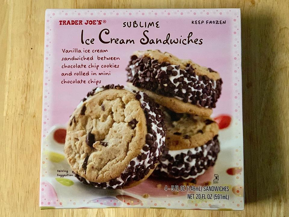 Pink box of trader Joe's ice-cream cookie sandwiches on wood table