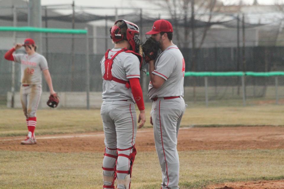 Devils Lake pitcher Simon Beach (right) has a mound visit with Devils Lake catcher Hayden Hofstad (left).