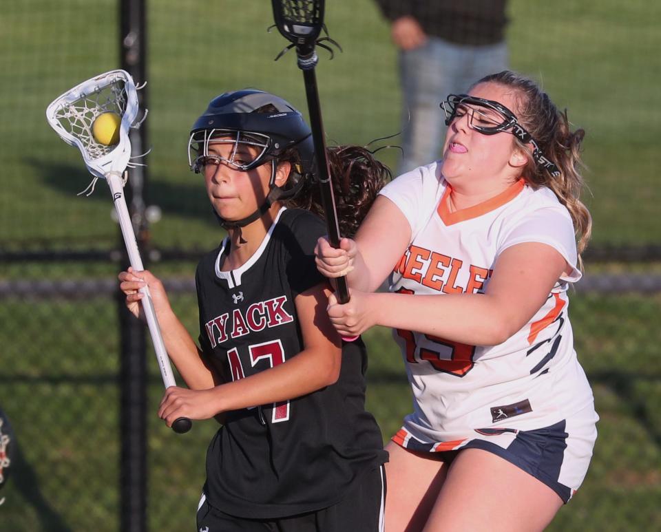 Nyack's Ella Gould is pressured by Horace Greeley's  Dylan Dammers during their game at Horace Greeley April 25, 2023. Nyack won 16-6.