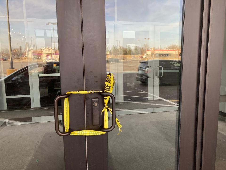 Crime scene tape surrounds the handles of the front doors of VASA Fitness, 6965 W 38th St., after a shooting there Feb. 6, 2024 left two people injured.