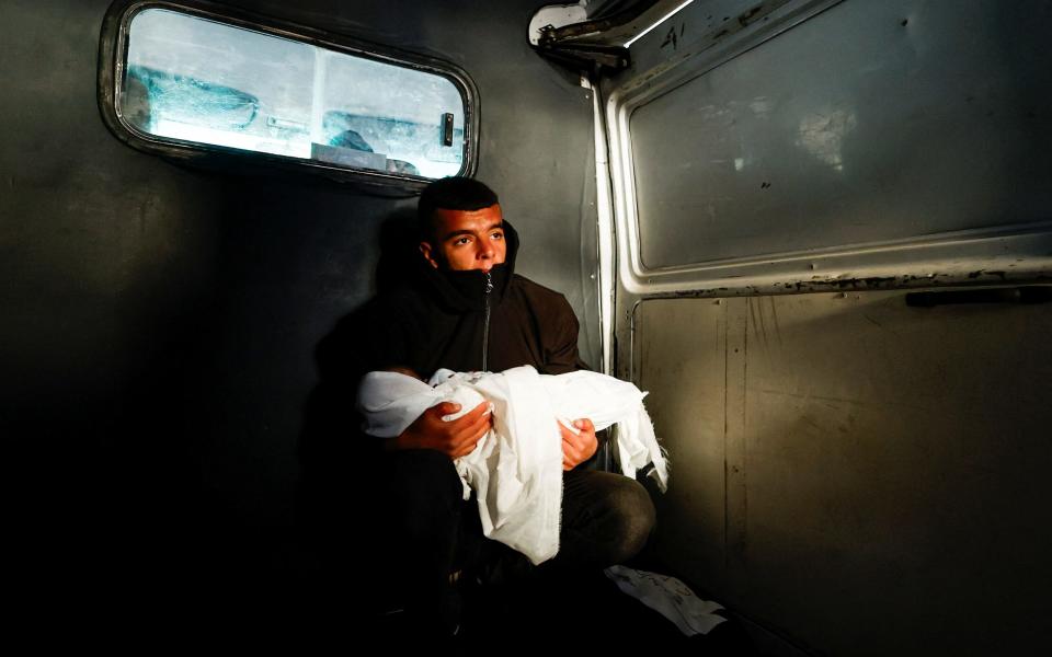 A mourner reacts during the funeral of the Palestinian twins Wesam and Naeem Abu Anza, who were born during the conflict between Israel and Hamas and were killed in Israeli air strikes, in Rafah in the southern Gaza Strip March 3, 202