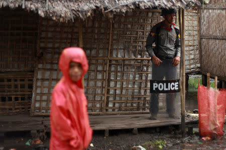 A policeman stands guard as former U.N. chief Kofi Annan (not in picture) attends a meeting with local leaders at the Aung Mingalar Rohingya internally displaced persons (IDP) camp in Sittwe, Myanmar, September 7, 2016. REUTERS/Wa Lone