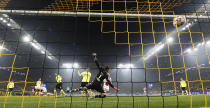 Ajax's Sebastien Haller, left, hscores his side's second goal against Dortmund's goalkeeper Gregor Kobel during the Champions League group C soccer match between Borussia Dortmund and Ajax Amsterdam in Dortmund, Germany, Wednesday, Nov. 3, 2021. (AP Photo/Martin Meissner)