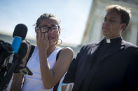 <p>A girl cries as she speaks to the press outside the Supreme Court about her father who was detained by ICE agents after they released a decision about the travel ban Tuesday June 26, 2018. (Photo: Sarah Silbiger/CQ Roll Call/Getty Images) </p>
