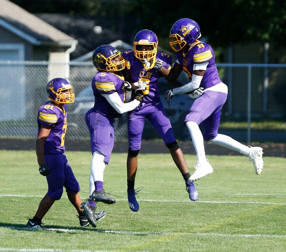South Bend Clay football players react after Tyrese Jones's game-ending interception return for a touchdown against North Newton Saturday, Sept. 30, 2023, at Clay Middle School in South Bend.