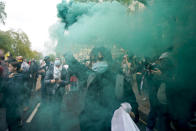 A demonstrator holds a flare during a march in solidarity with the Palestinian people amid the ongoing conflict with Israel, during a demonstration in London, Saturday, May 15, 2021. (AP Photo/Alberto Pezzali)