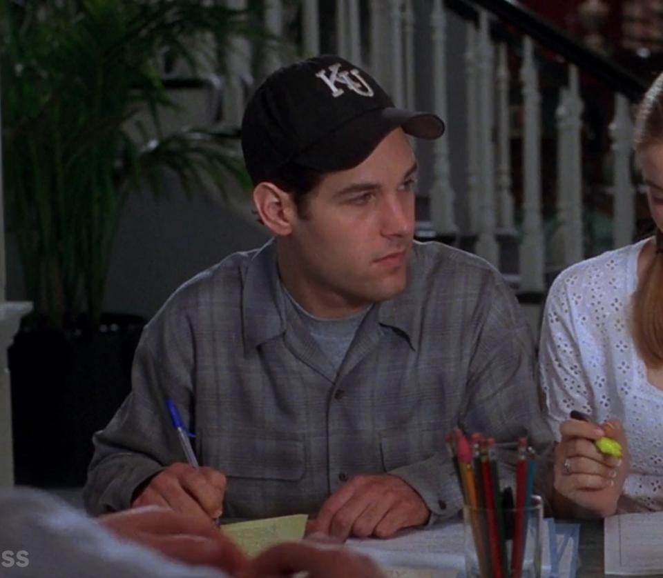 Paul Rudd as Josh does some paperwork alongside Cher in "Clueless"