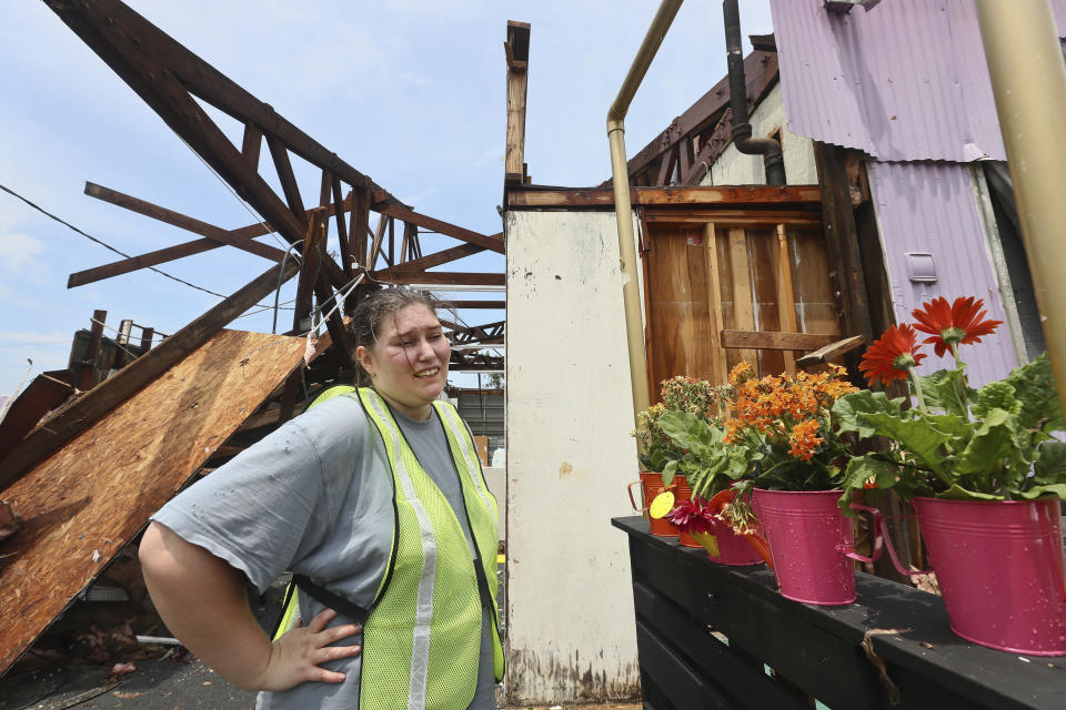 Lauren Walker, co-founder of Able Artist's Gallery, reacts after salvaging some flower arrangements she was hoping to sell for Mother's Day at her Railroad Square business in Tallahassee, Fla., Friday, May 10, 2024. Some of the strongest storms early Friday rolled through Tallahassee, toppling trees across the state's capital city. (AP Photo/Phil Sears)