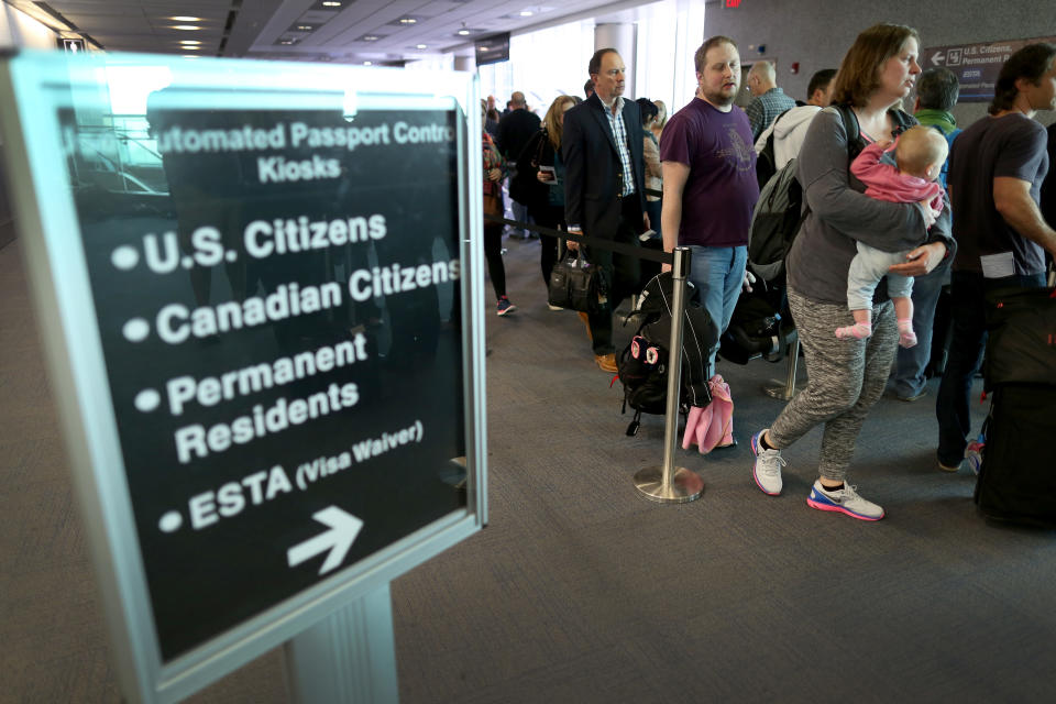 Pasajeros esperan en fila para utilizar los quioscos automatizados de control de pasaportes configurados para viajeros internacionales que llegan al Aeropuerto Internacional de Miami el 4 de marzo de 2015 en Miami, Florida. (Foto de Joe Raedle/Getty Images)