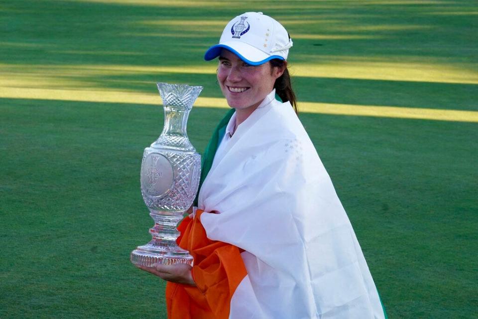 Europe's Leona Maguire holds the trophy after their team defeated the United States at the Solheim Cup golf tournament, Monday, Sept. 6, 2021, in Toledo, Ohio. (AP Photo/Carlos Osorio)