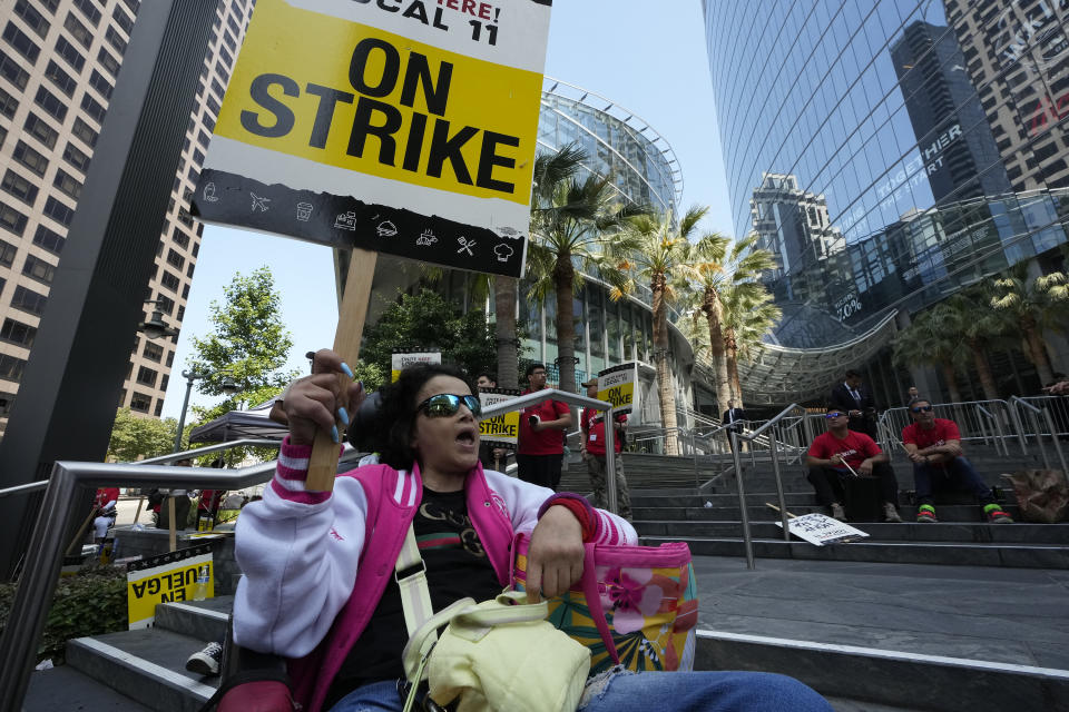 Striking hotel worker Tayra Dehart joins a rally outside the Intercontinental Hotel on Monday, July 3, 2023, in downtown Los Angeles. (AP Photo/Damian Dovarganes)