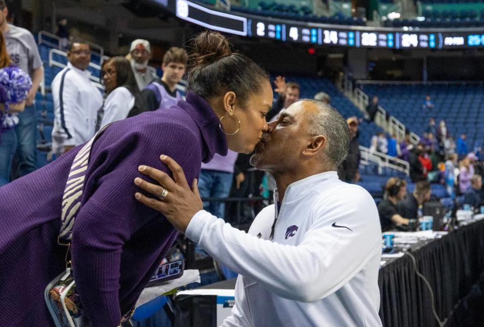 Kansas State coach Jerome Tang kisses his wife Careylyen after picking up his first NCAA Tournament victory as a head coach after defeating Montana State in Greensboro, NC on Friday night.