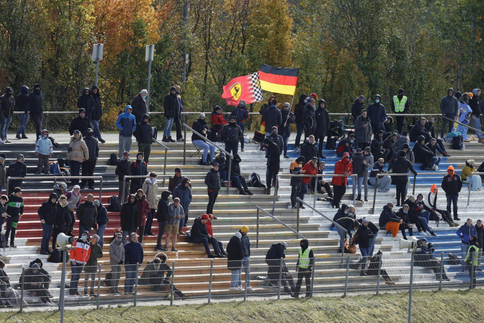 Spectators are on stands ahead of qualification for the Eifel Formula One Grand Prix at the Nuerburgring racetrack in Nuerburg, Germany, Saturday, Oct. 10, 2020. The Germany F1 Grand Prix will be held on Sunday. (Ronald Wittek, Pool via AP)