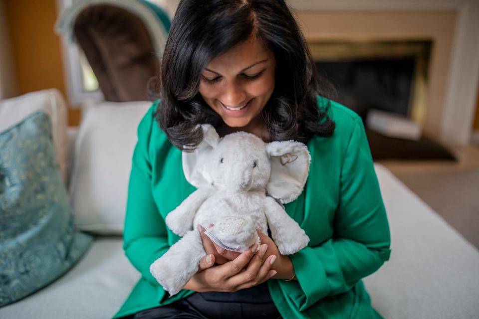 Sveta Prakash Desai, 40, has breast cancer that is currently in remission and holds a stuffed elephant her surrogate sent her while she sits for a portrait at the home she shares with her mother in Troy, Mich., on Nov. 16, 2023. Desai wants to have a child after completing cancer treatment, but her body didn't cooperate. After five failed eggs following a retrieval (before her diagnosis) and an aggressive cancer, Sveta is now expecting a baby via surrogate this March.
